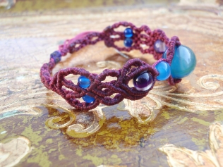 Macramé bracelet with blue and violet beads